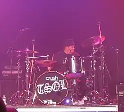 Biuso behind a drum kit that reads "TSOL"
