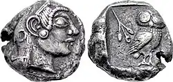 Both sides of a silver coin. One side shows a head in profile; the other an owl.
