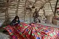 A Baloch woman weaving a blanket
