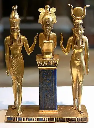 Osiris on a lapis lazuli pillar in the middle, flanked by Horus on the left, and Isis on the right, between 874 and 850 BCE, Louvre