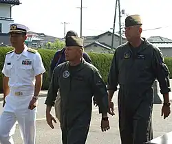 Japanese Self Defense Armed Forces (JSDAF), Major General (MGEN) Matuoka Sadayosi, US Marine Corps (USMC) Colonel (COL) Dave Darrah and USMC COL Stephen Pomeroy, walk toward the main gate for the opening ceremonies of Friendship Day at Marine Corps Air Station (MCAS) Iwakuni, Japan.