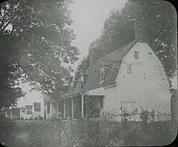 Long Point House when it served as a lodge for visiting hunters. The lodge buildings, positioned adjacent to the house, burned before 1926